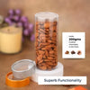 Jar of almonds with a label and spoon on a wooden surface
